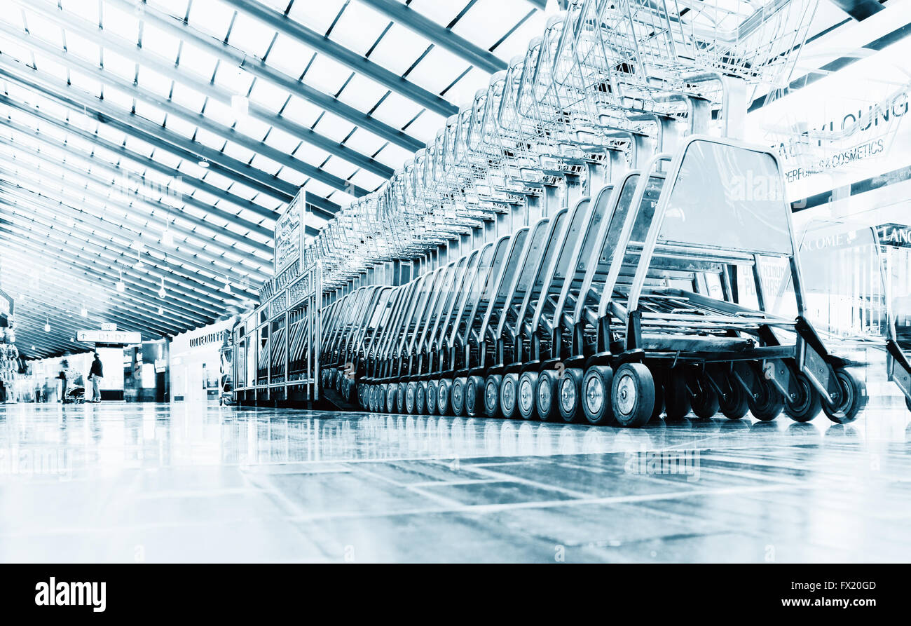 number of luggage carts at modern airport, blue colored Stock Photo