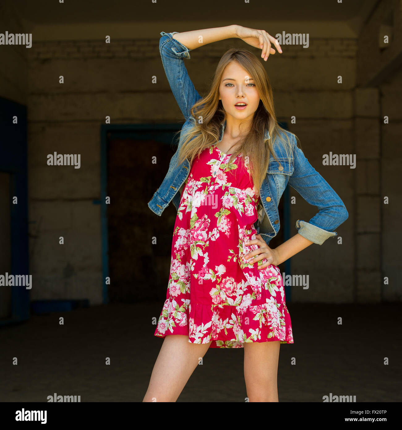 Teen Girl Raising Her Hand Above Her Head Posing In Photo Shoot Stock Photo Alamy