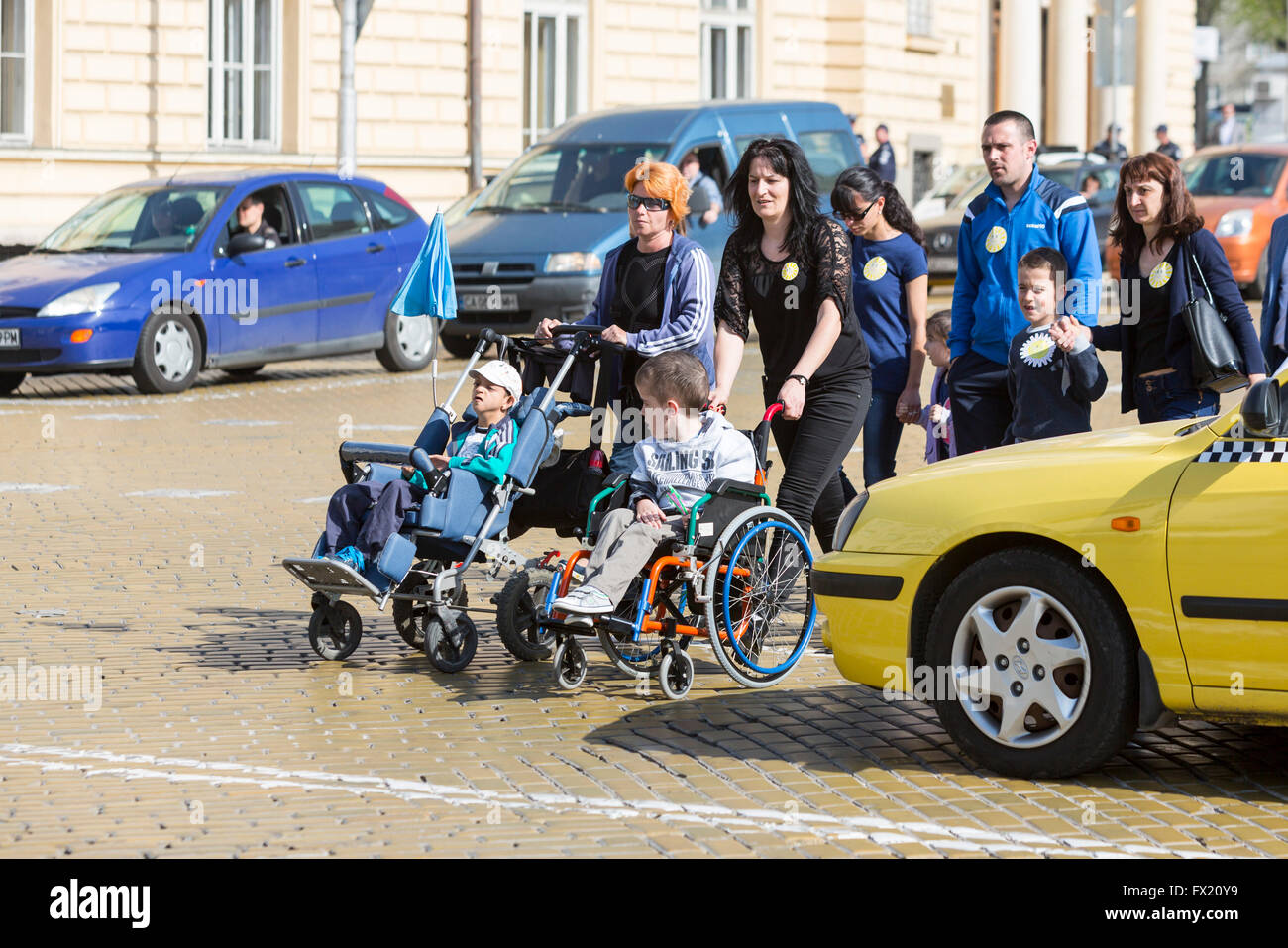 Sofia, Bulgaria - April 6, 2016: Physically and mentally disabled are accompanied by their parents, relatives and friends at a p Stock Photo