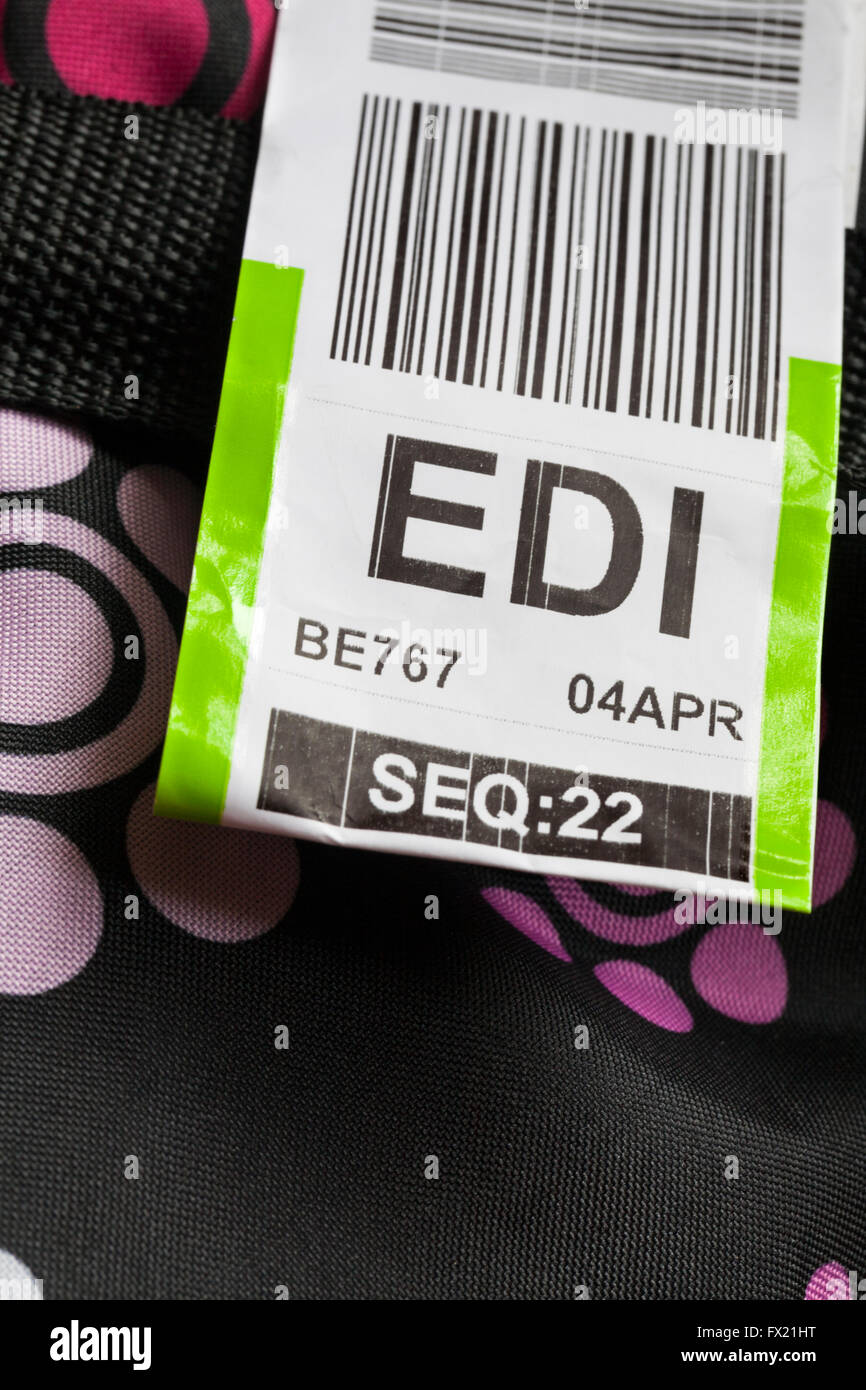 Flybe luggage label stuck on case for EDI Edinburgh airport Stock Photo