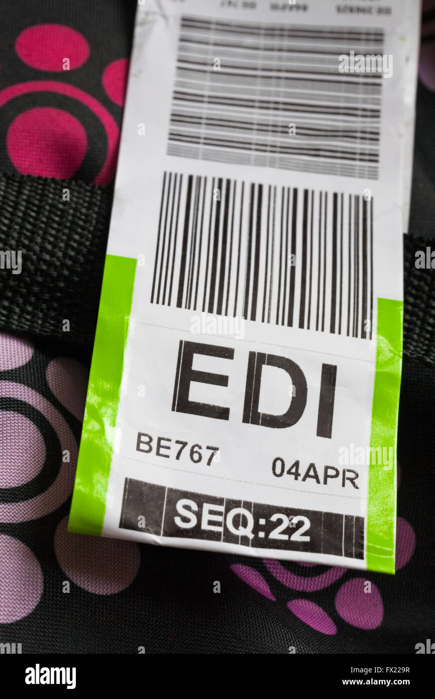 Flybe luggage label stuck on case for EDI Edinburgh airport Stock Photo