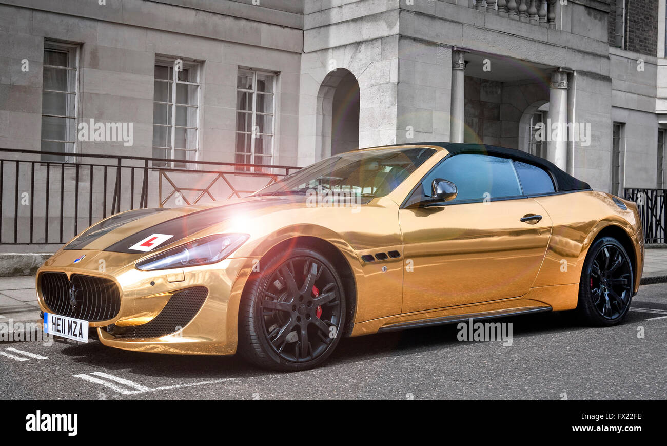 Gold plated Maserati Grand Turismo Convertible MC with a learner drivers L plate attached,parked in a street in Mayfair London Stock Photo