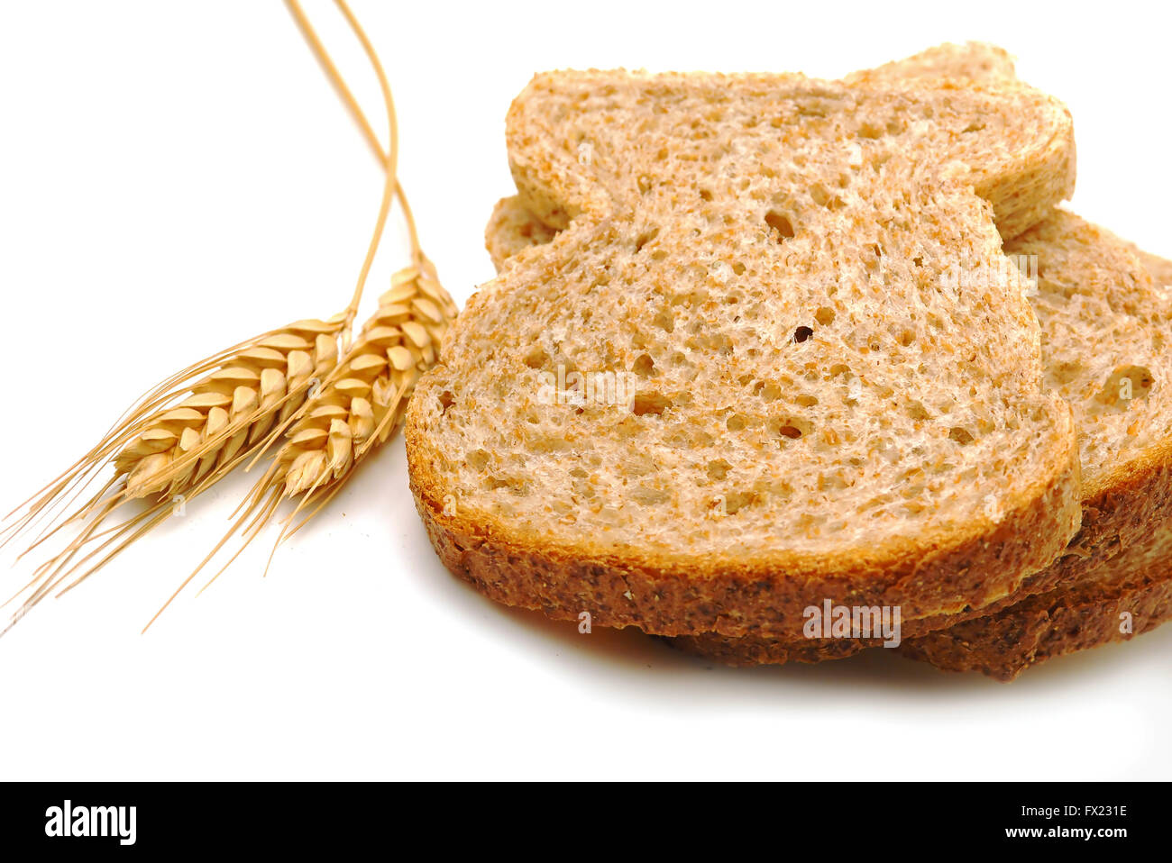 Whole wheat bread slices on white background Stock Photo - Alamy
