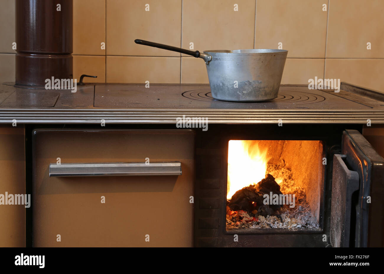 ancient woodburning stove in the kitchen of mountain home Stock Photo Alamy