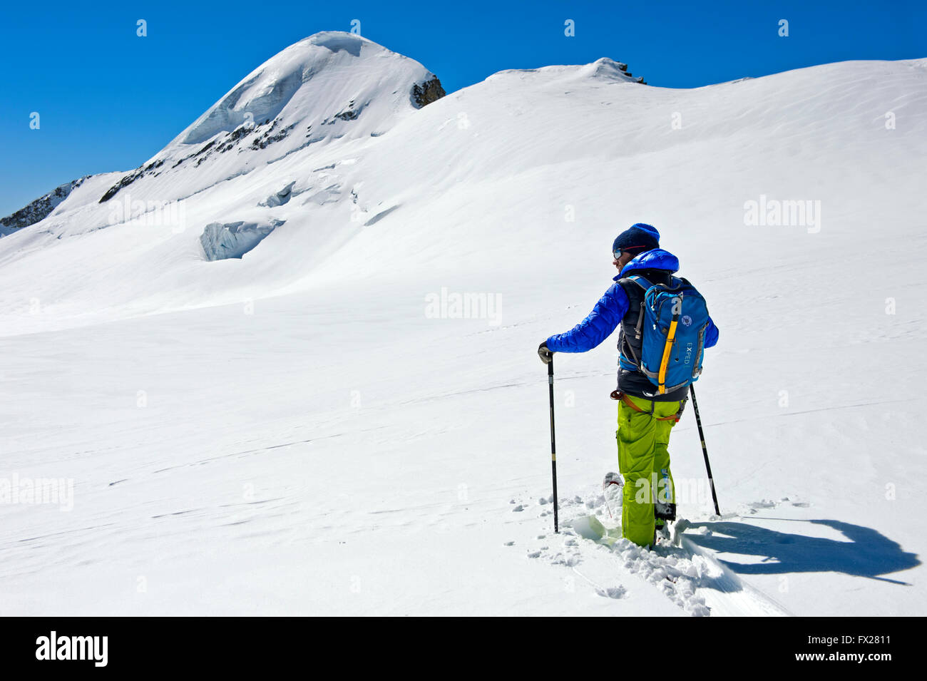 Skier on a ski tour on the Aebeni Flue firn fiel beneath the Mittagshorn peak, Loetschental, Valais, Switzerland Stock Photo