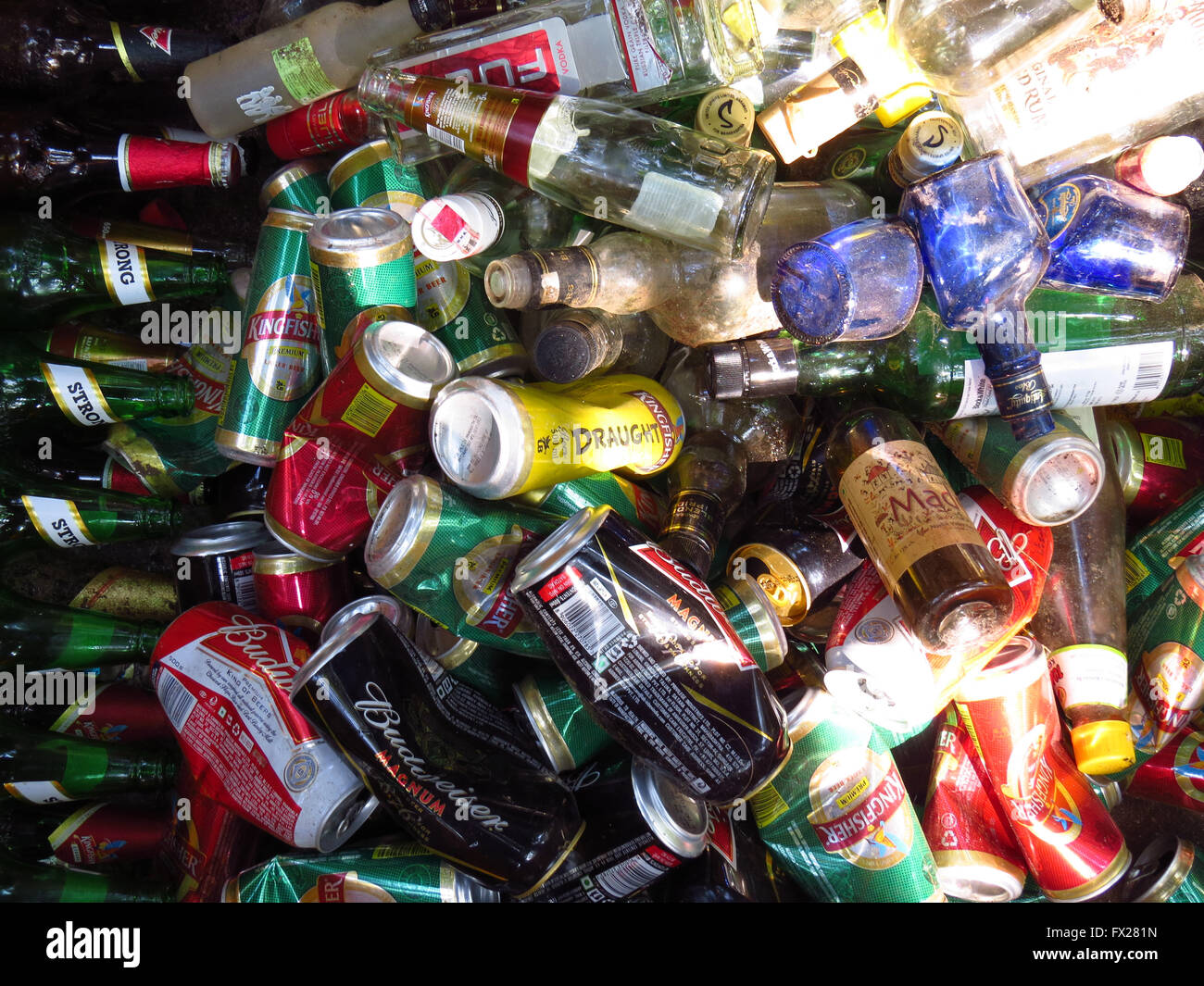 A background of thrash of alcohol bottles and cans lying in the ...