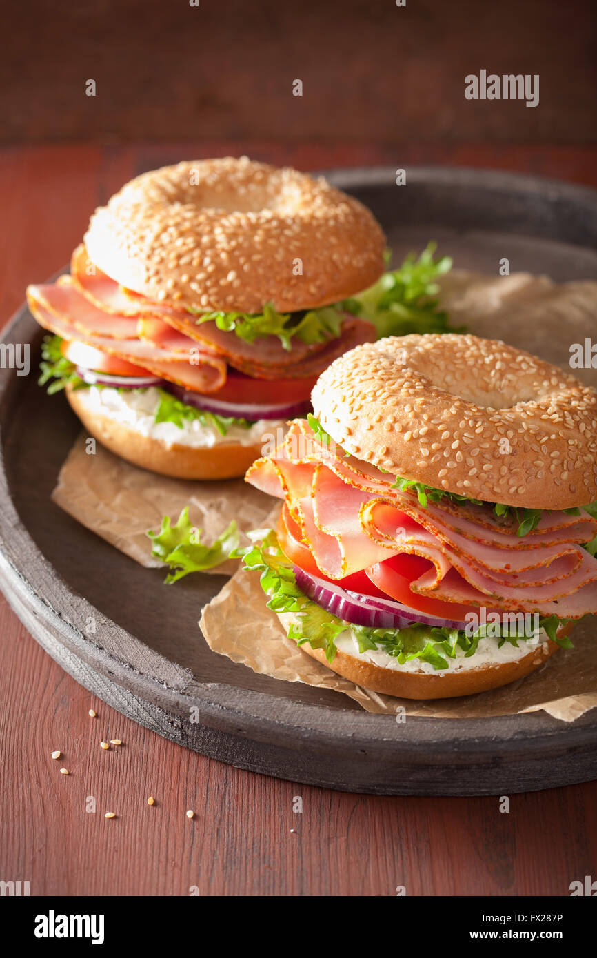 ham sandwich on bagel with cream cheese tomato onion Stock Photo Alamy