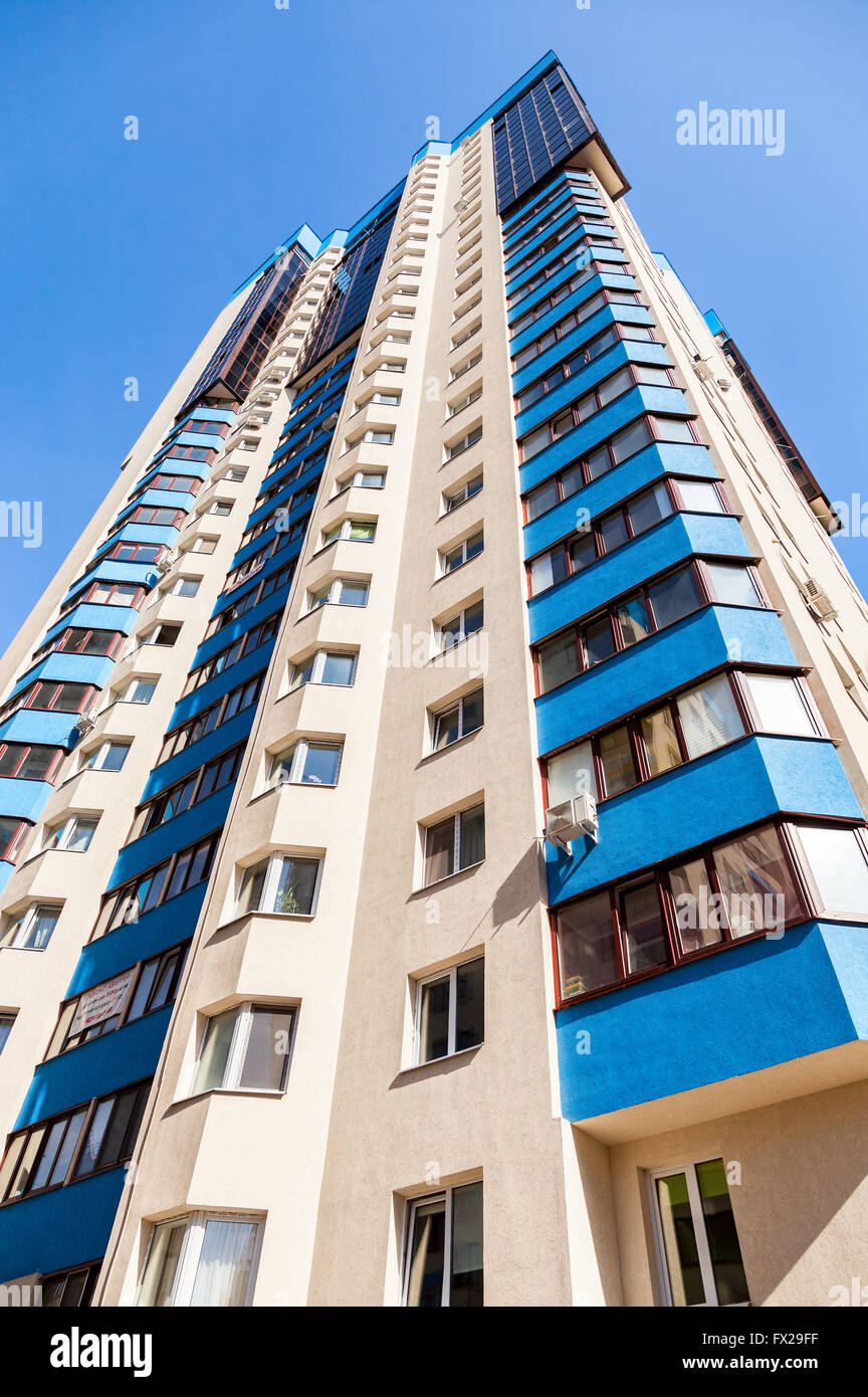 New tall apartment buildings against blue sky background Stock Photo ...