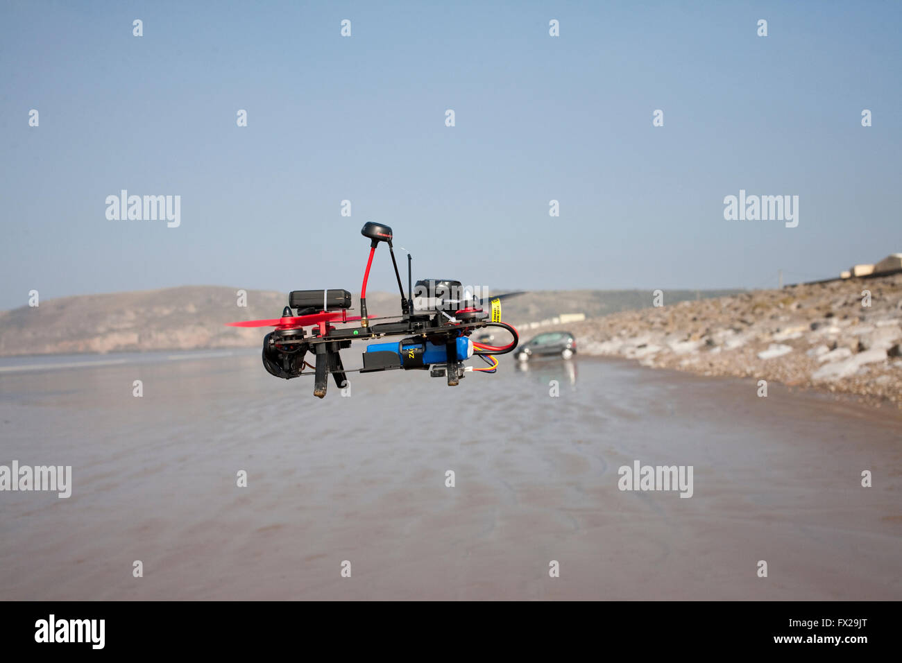 radio controlled drone being flown on an empty beach Stock Photo