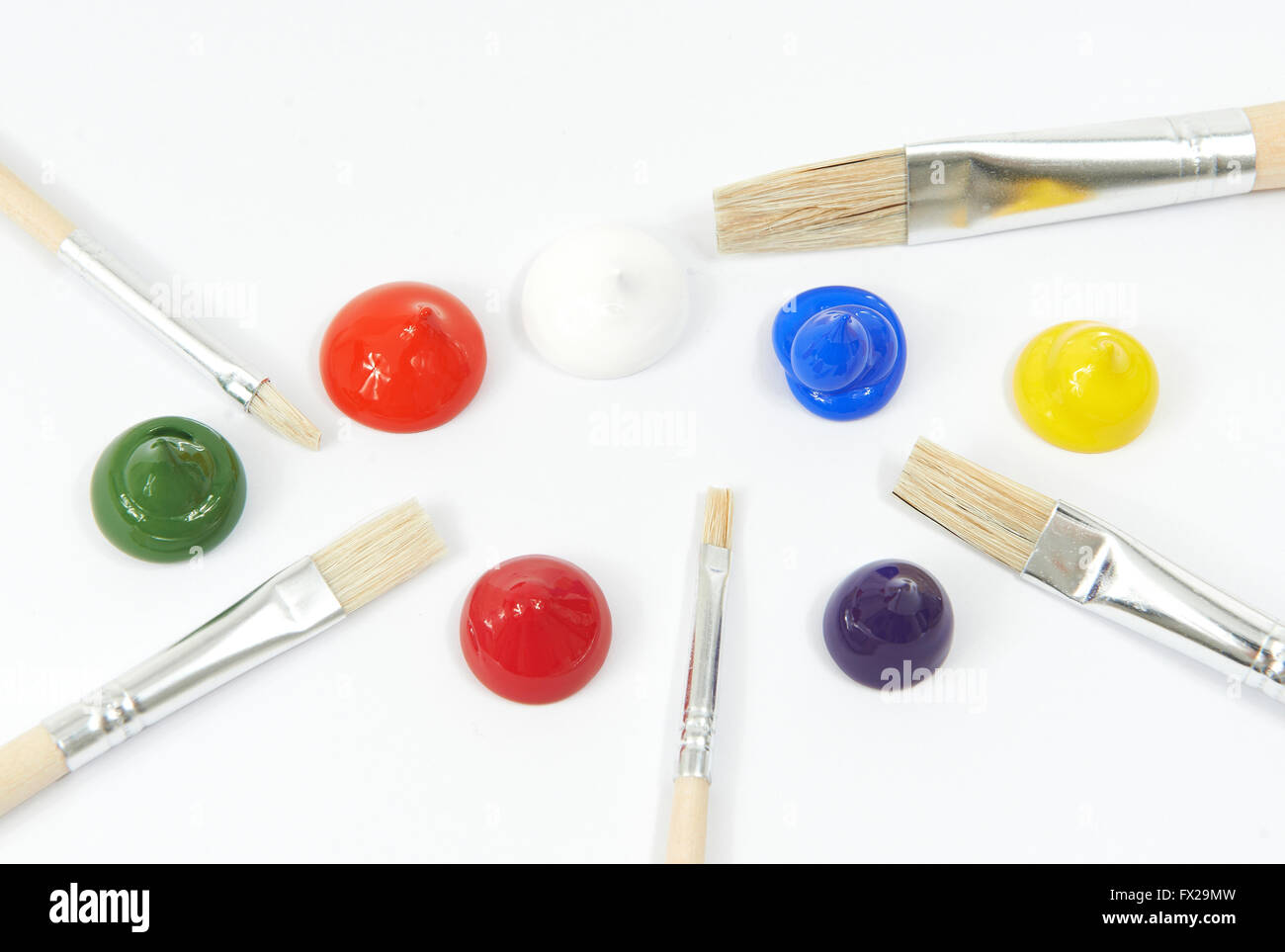 Acrylic colors and paint brushes on a white background Stock Photo