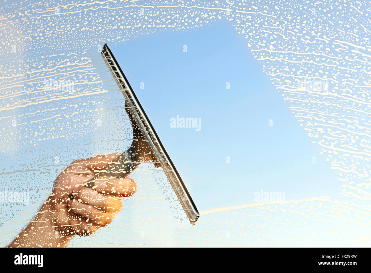 Hand washing and cleaning window with professionally squeegee portable  vacuum cleaner. Maid cleans window Stock Photo - Alamy
