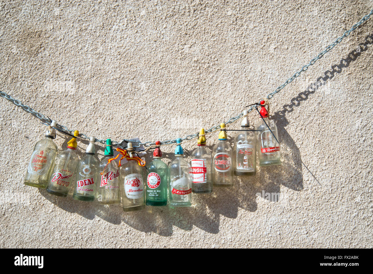Empty Gaseosa bottles hanging on a chain. Chinchon, Madrid province