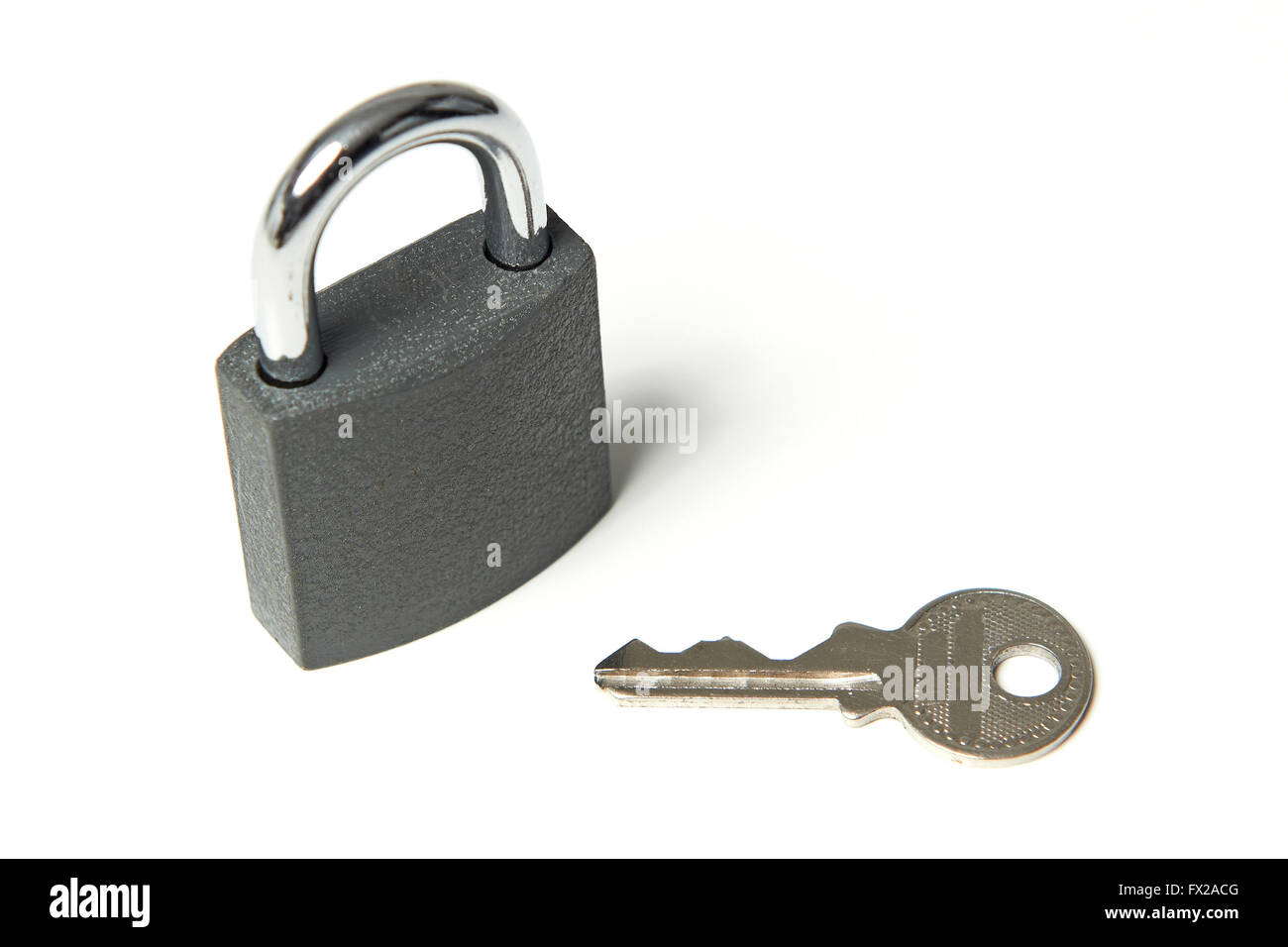 Padlock with key next to it on a white background Stock Photo - Alamy