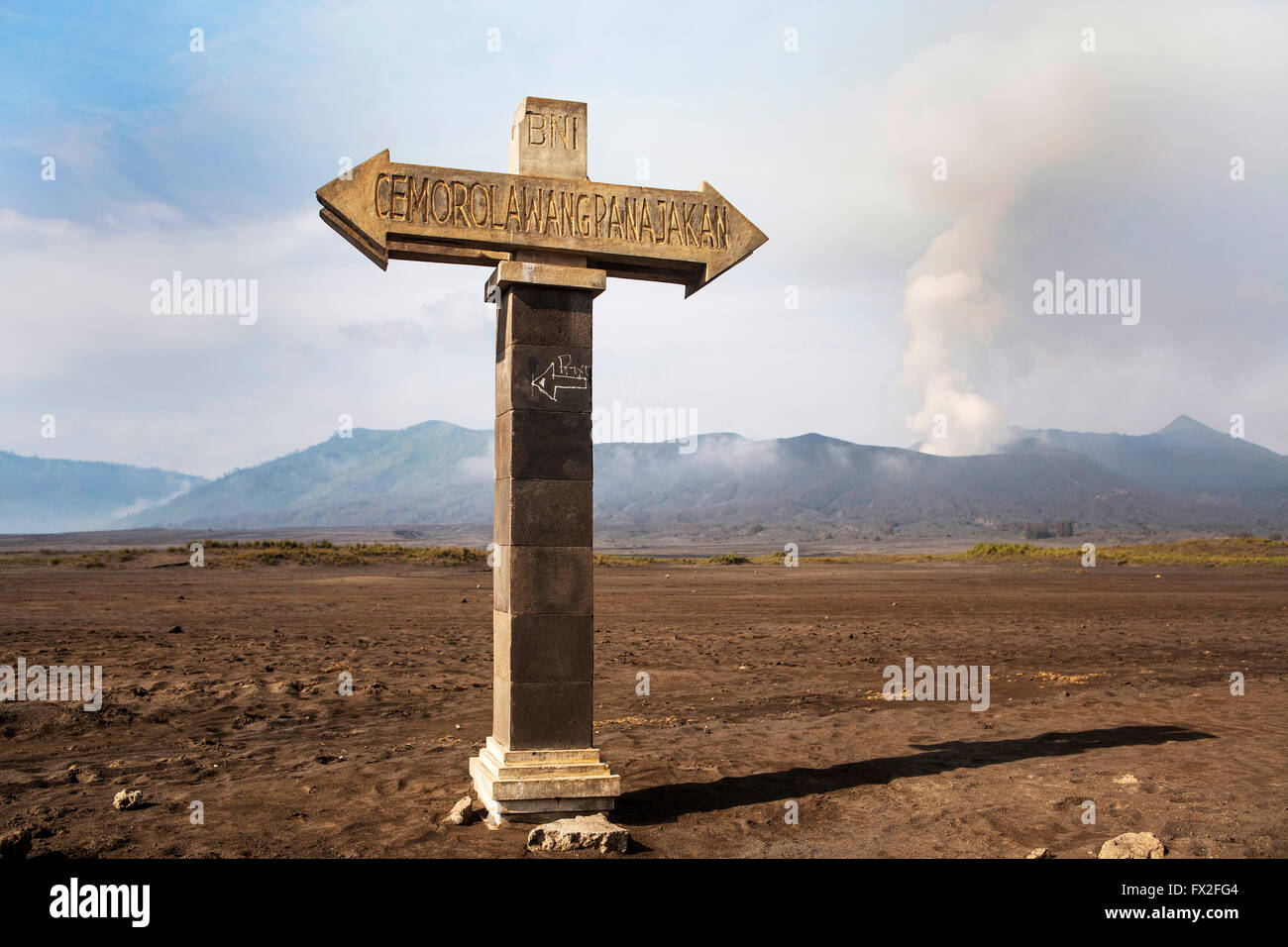 Signposts pointing to the bottom of the volcano caldera. Mt. Bromo volcano during sunrise, the magnificent view of Mt. Bromo loc Stock Photo