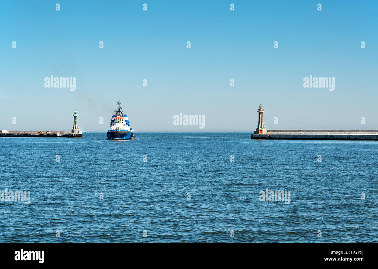 A tugboat entering the harbor in Gdynia, Poland Stock Photo