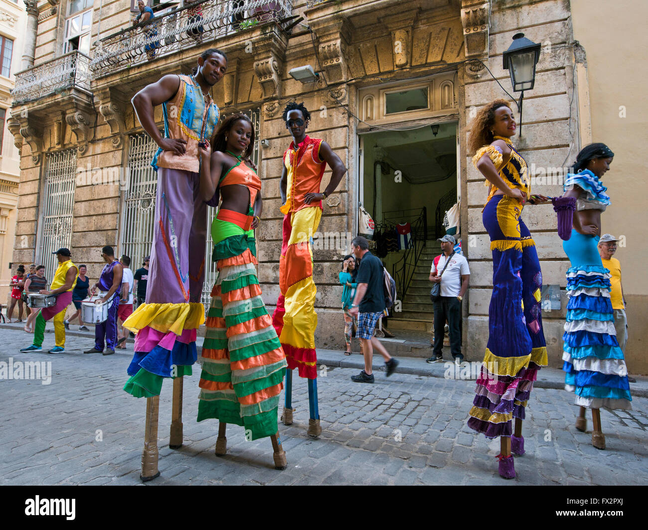 Horizontal portrait of stilt walkers posing for a photograph in Havana, Cuba. Stock Photo