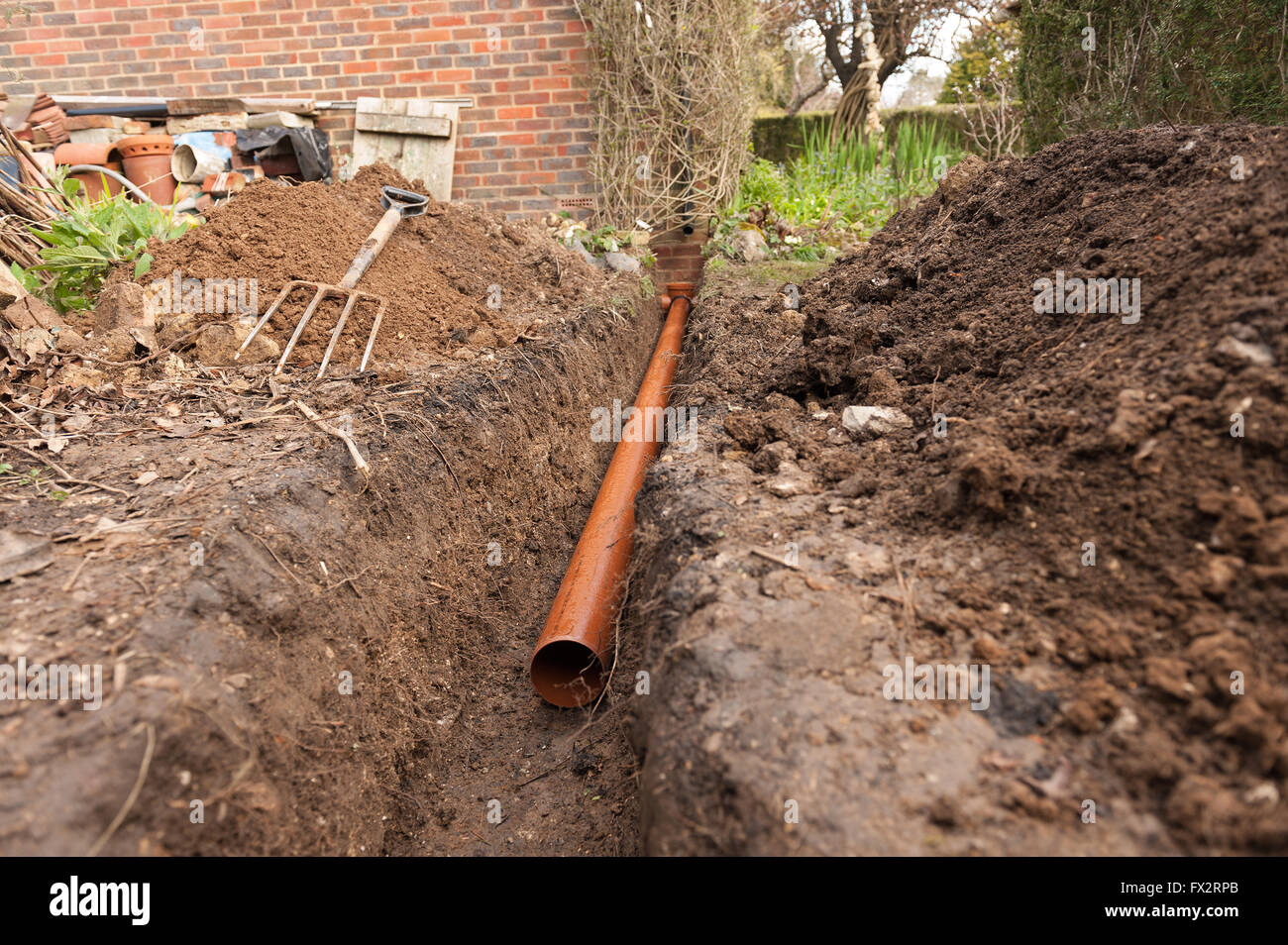 6m soil pipe run to comply with building regulations and soakaway for drainage in trench through