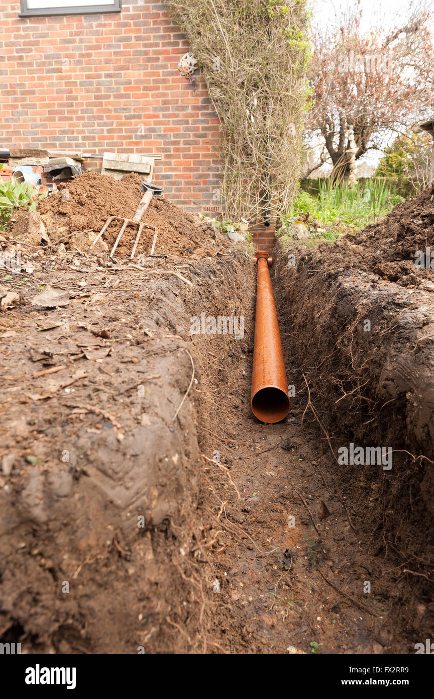 6m soil pipe run to comply with building regulations and soakaway  for drainage in trench through chalky soil and clay Stock Photo
