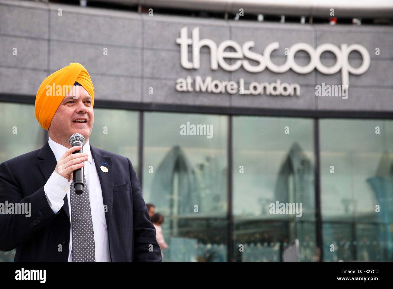 City Hall, London, UK. 9 April 2016. Roger Evans Deputy Mayor of London wearing turban addresses the crowd.. Sikhs  from all over the UK celebrates festival of Vaisakhi, (Sikhs’ New Year) inside and outside the City Hall and The Scoop in central London, celebrating the Sikh tradition, heritage, culture, shabad kirtan (spiritual music), langar (food), turban tying, folk music, martial arts, dancing and children’s activities.The festival  is organised by the Mayor of London, with support from Singh Sabha London East and Ernst & Young Sikh Network. Credit:  Dinendra Haria/Alamy Live News Stock Photo