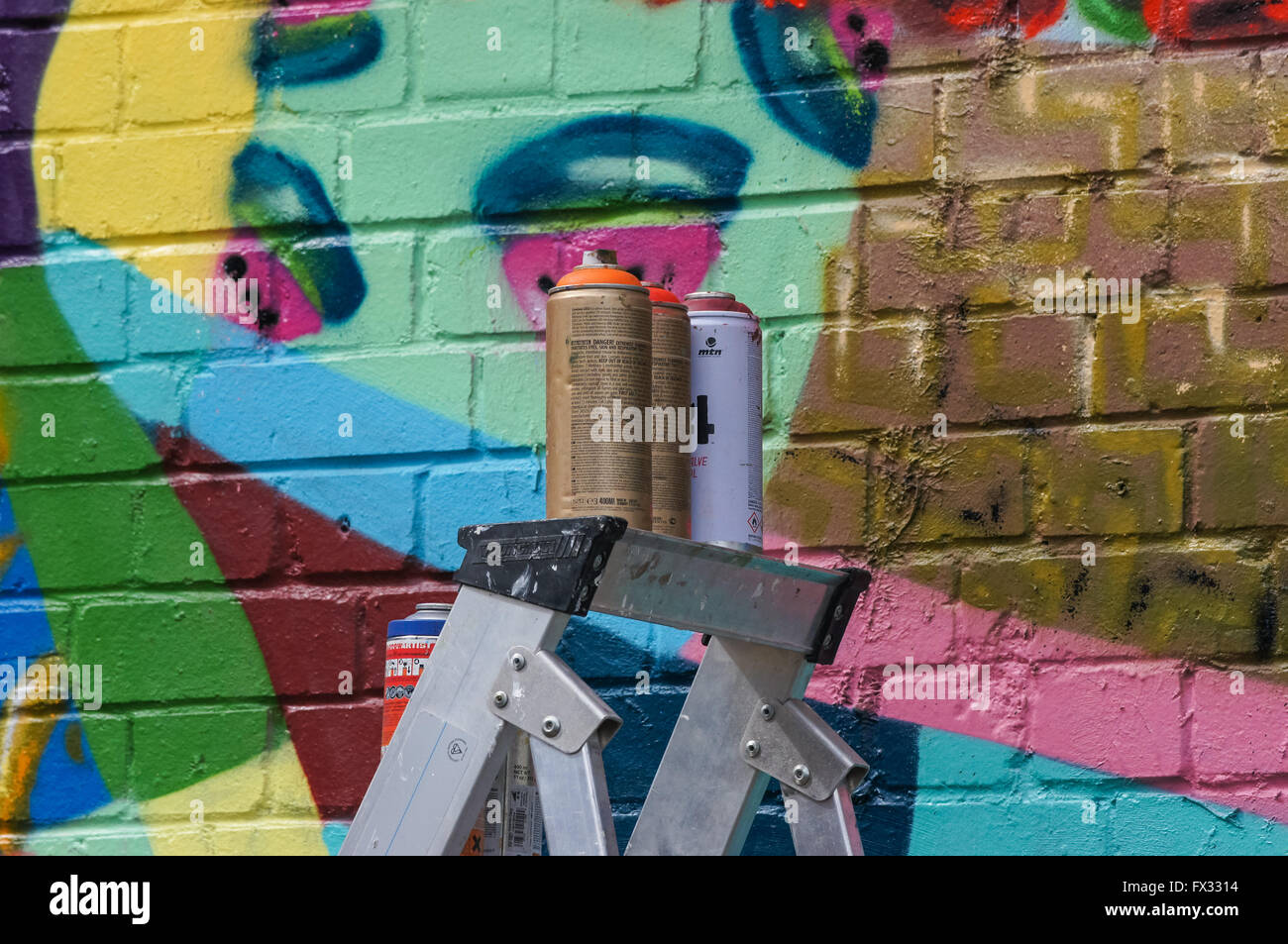 spray paint cans and graffiti mural Stock Photo