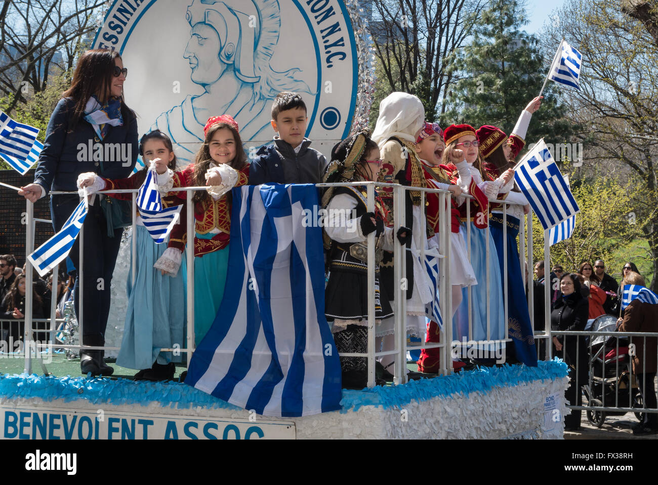 Children wearing traditional Greek costume waving flags in the 2016 New York Greek Parade Stock Photo