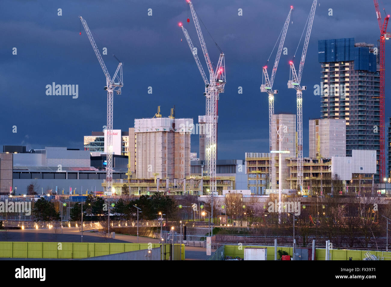 New skyscrapers in the International Quarter of the Queen Elizabeth Olympic Park stand out against a stormy twilight sky Stock Photo