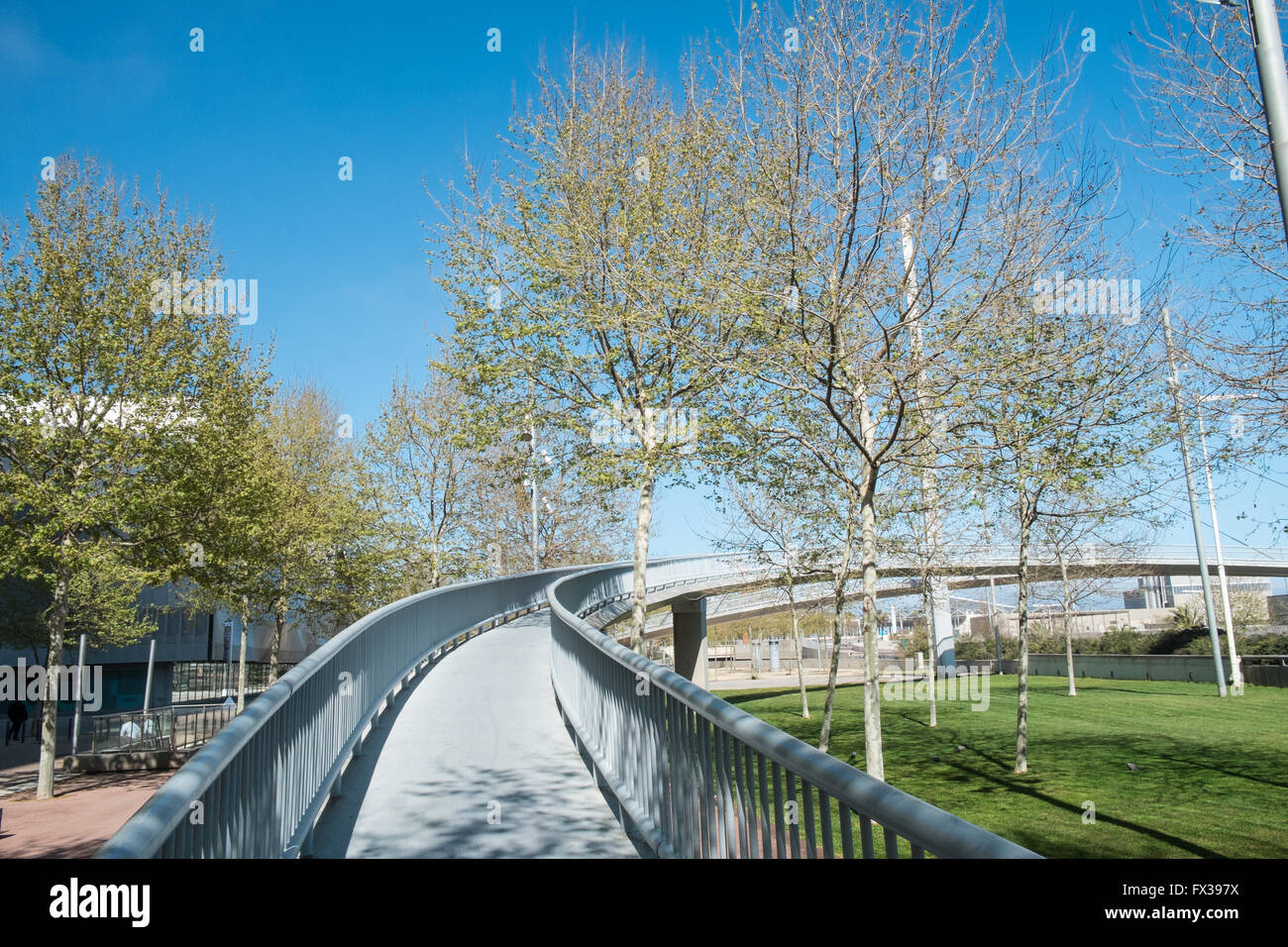 Curved pedestrian bridge over road,expressway in Diagonal Mar,next to CCIB Convention Centre,Barcelona,Catalonia,Spain,Europe. Stock Photo