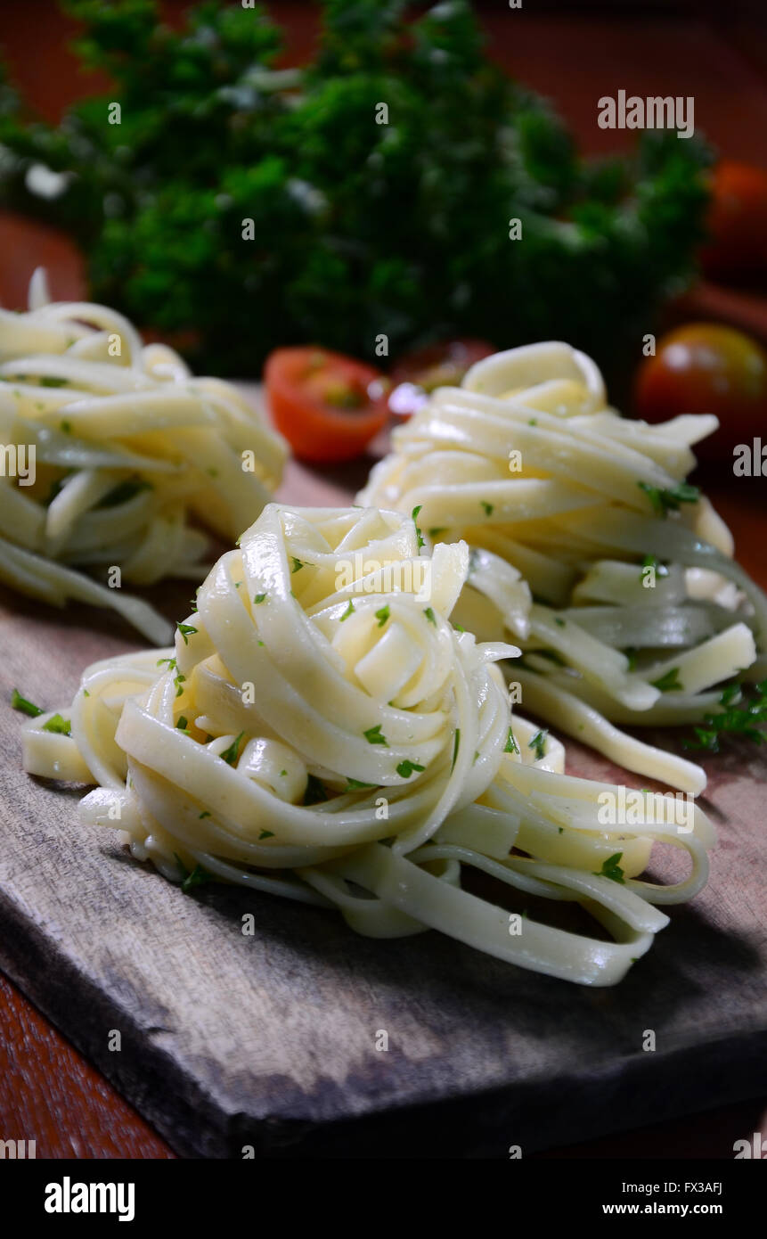 fettuccine aglio e olio with garnish cerry tomato and  parsley Stock Photo