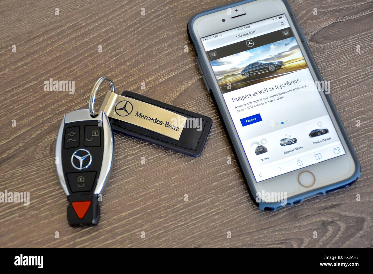An Apple iPhone displaying the MercedesBenz web page while laying next