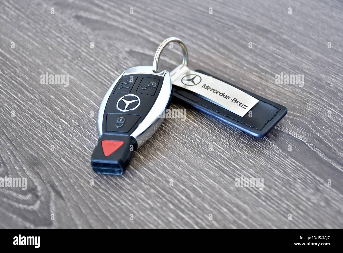 A Mercedes-Benz key fob laying on a wood surface Stock Photo - Alamy