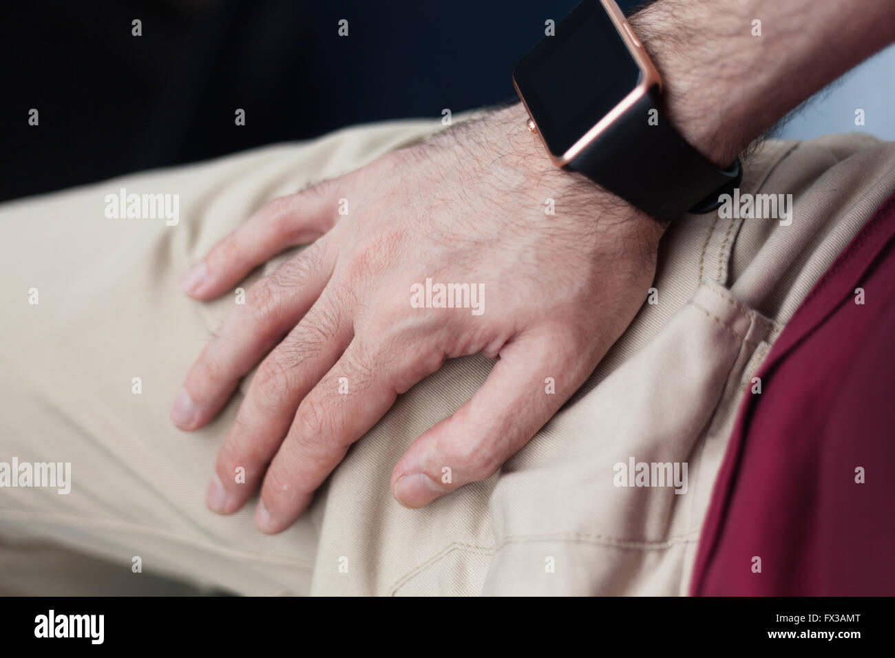 Male hand with trendy smart watch in focus. Elegant and stylish modern ...