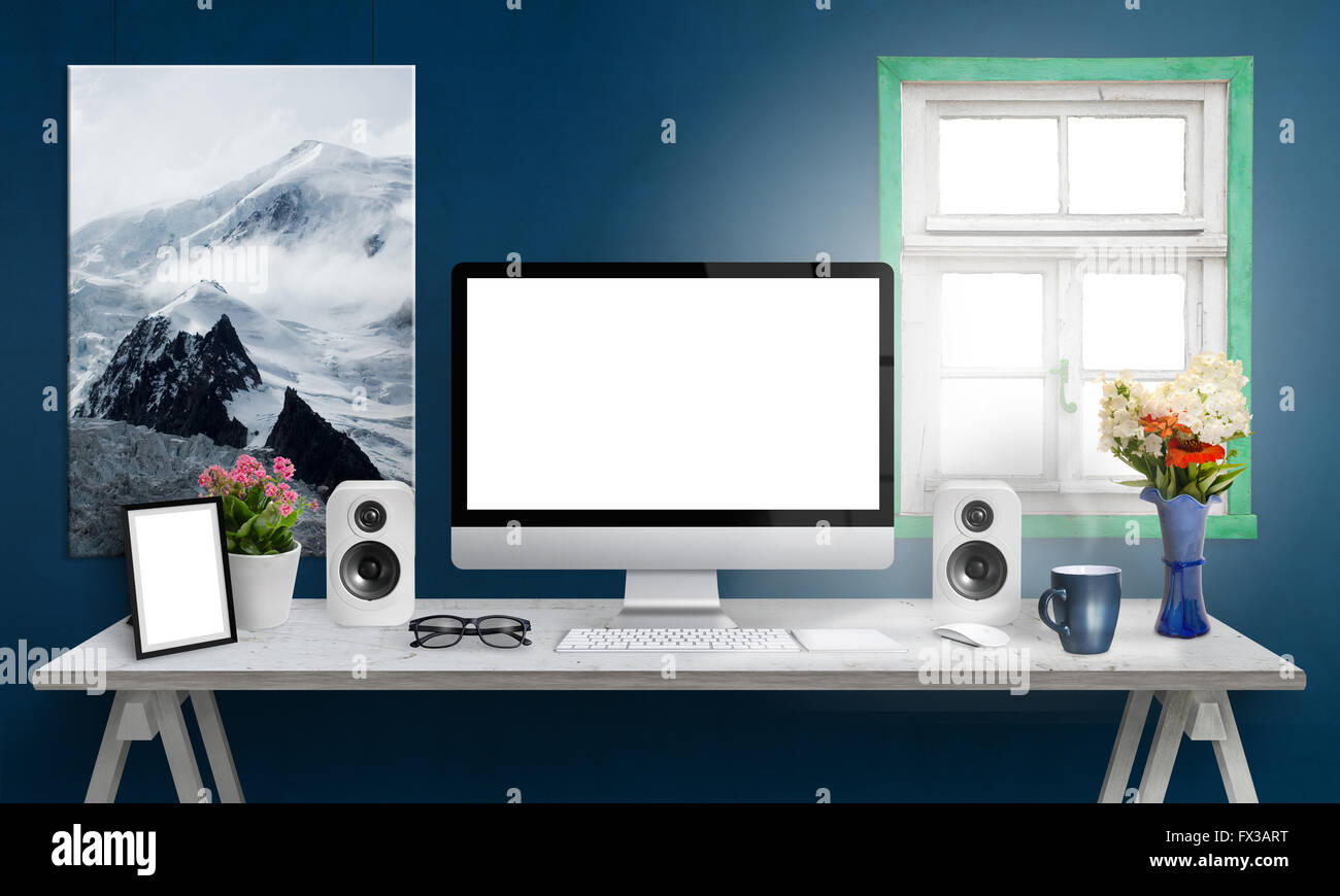 Computer display on office desk. Isolated, white screen for mockup. Creative modern desk with speakers, picture frame, glasses, Stock Photo