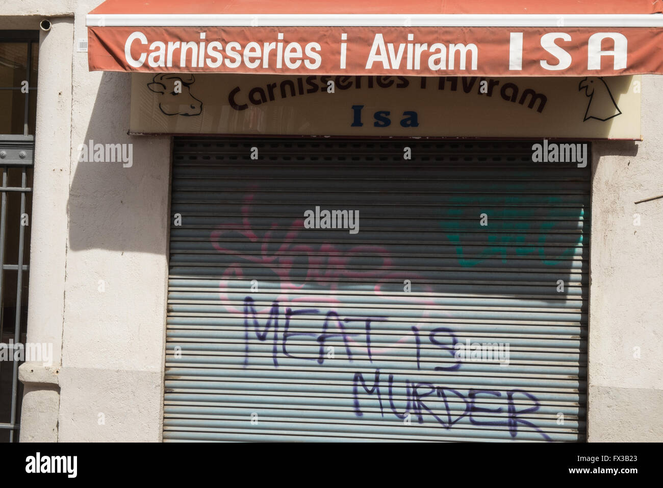 The Smiths Manchester rock band album title Meat Is Murder graffiti on shutters of butcher shop Barcelona,Catalonia,Spain,Europe Stock Photo