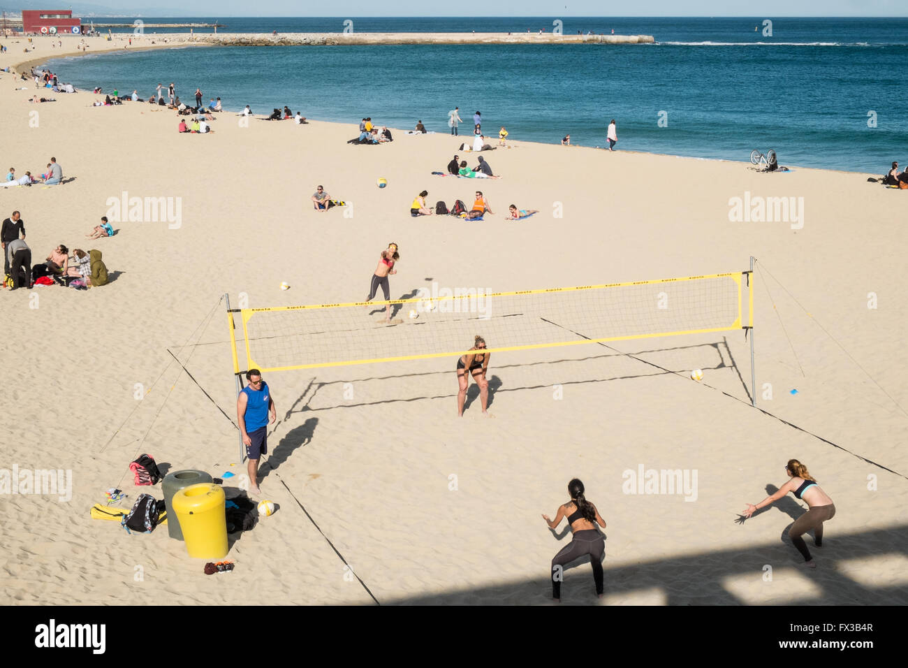 Playing Beach Volleyball on sandy sand at Playa,Plage, Nova Icaria Beach, Barcelona,Catalonia,Spain,Europe. Stock Photo