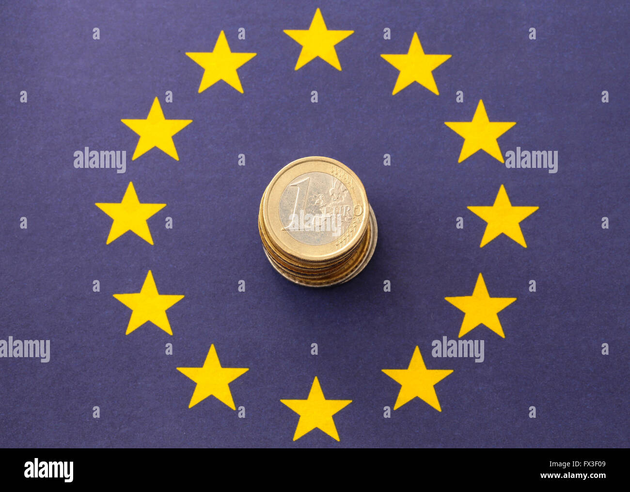 A pile of euro's on an European flag Stock Photo