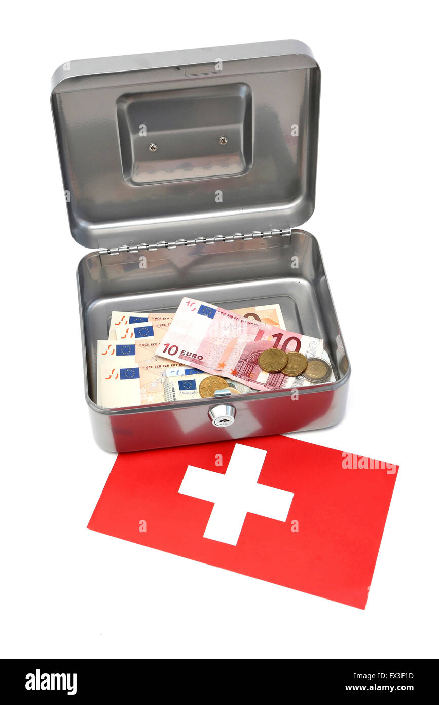 A money box filled with euro notes on top of a Swiss flag Stock Photo