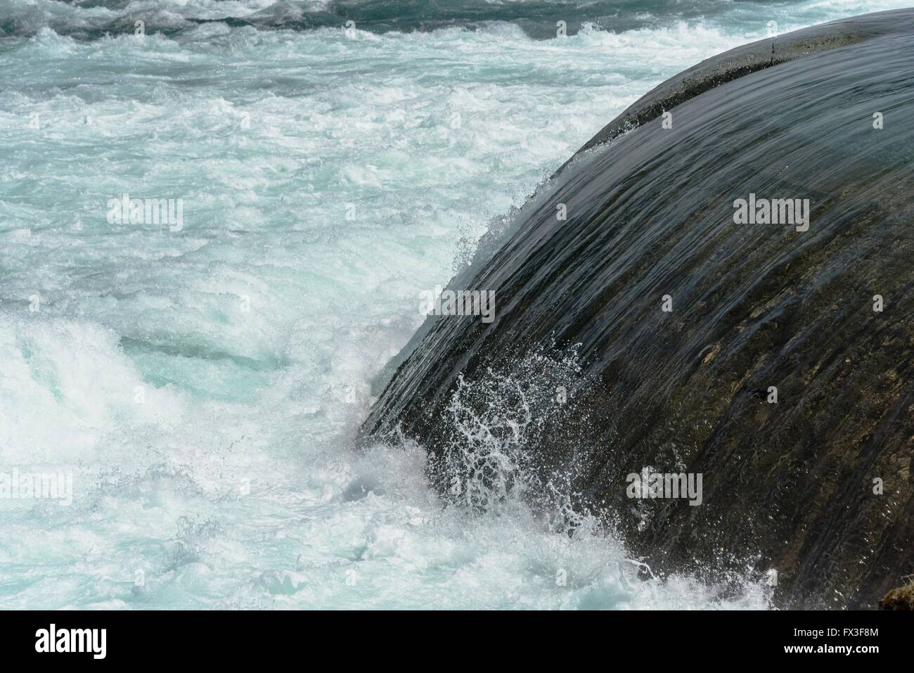Springtime swift flowing water from man made canal ports along the Niagara River rapids. Stock Photo
