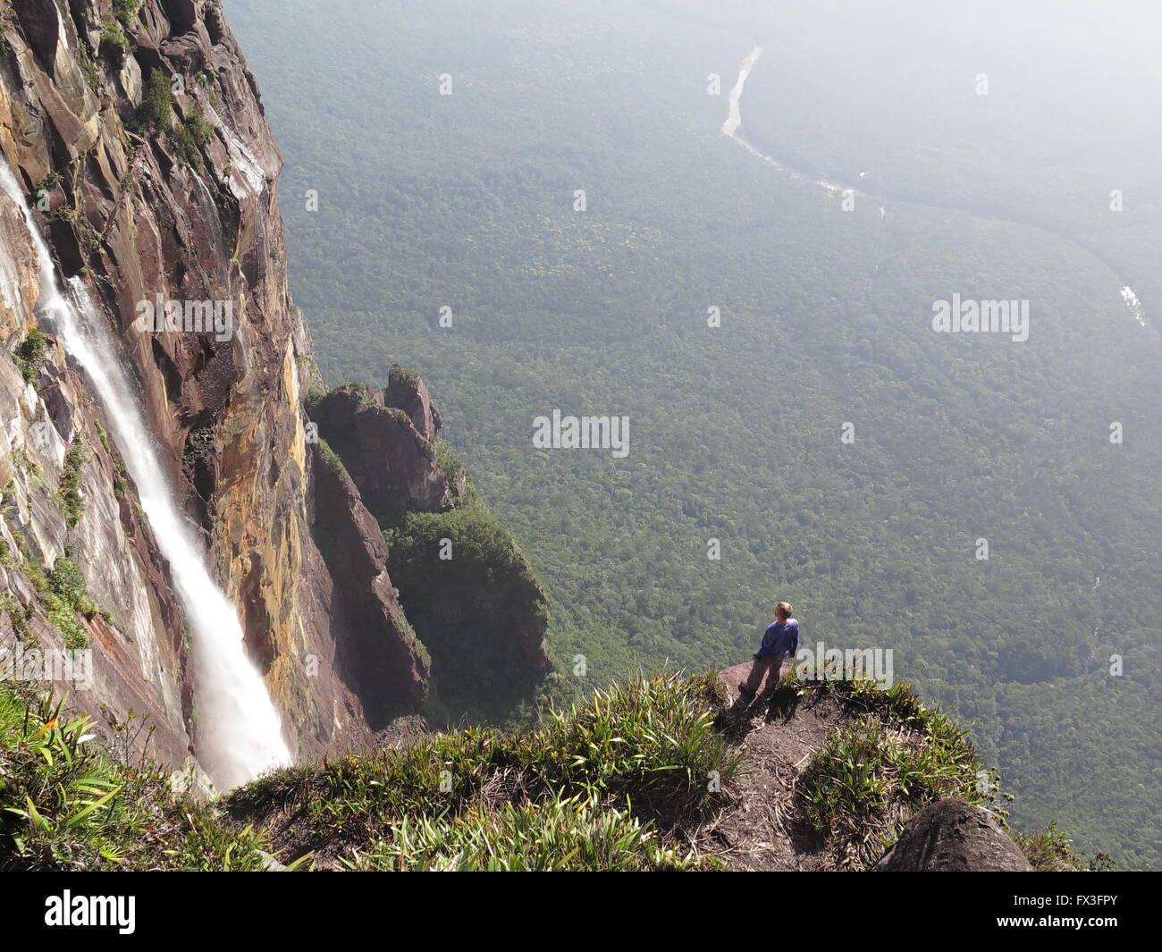 Men standing near the Angel Falls waterfall in Venezuela. Stock Photo
