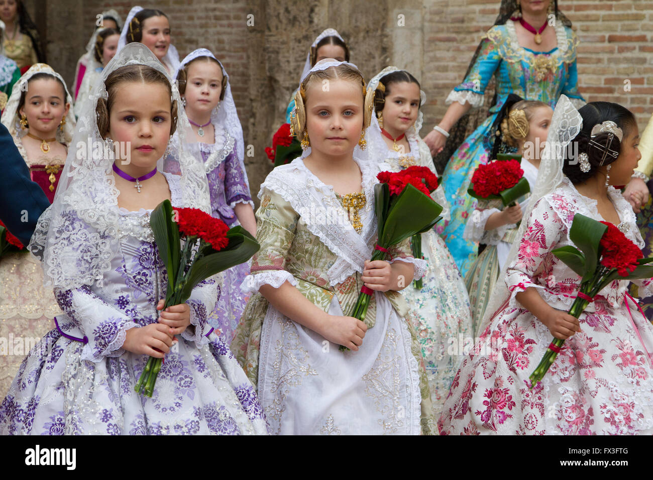 Children in traditional local costume attending the procession honouring the Lady of Valencia, Valencia Spain Stock Photo