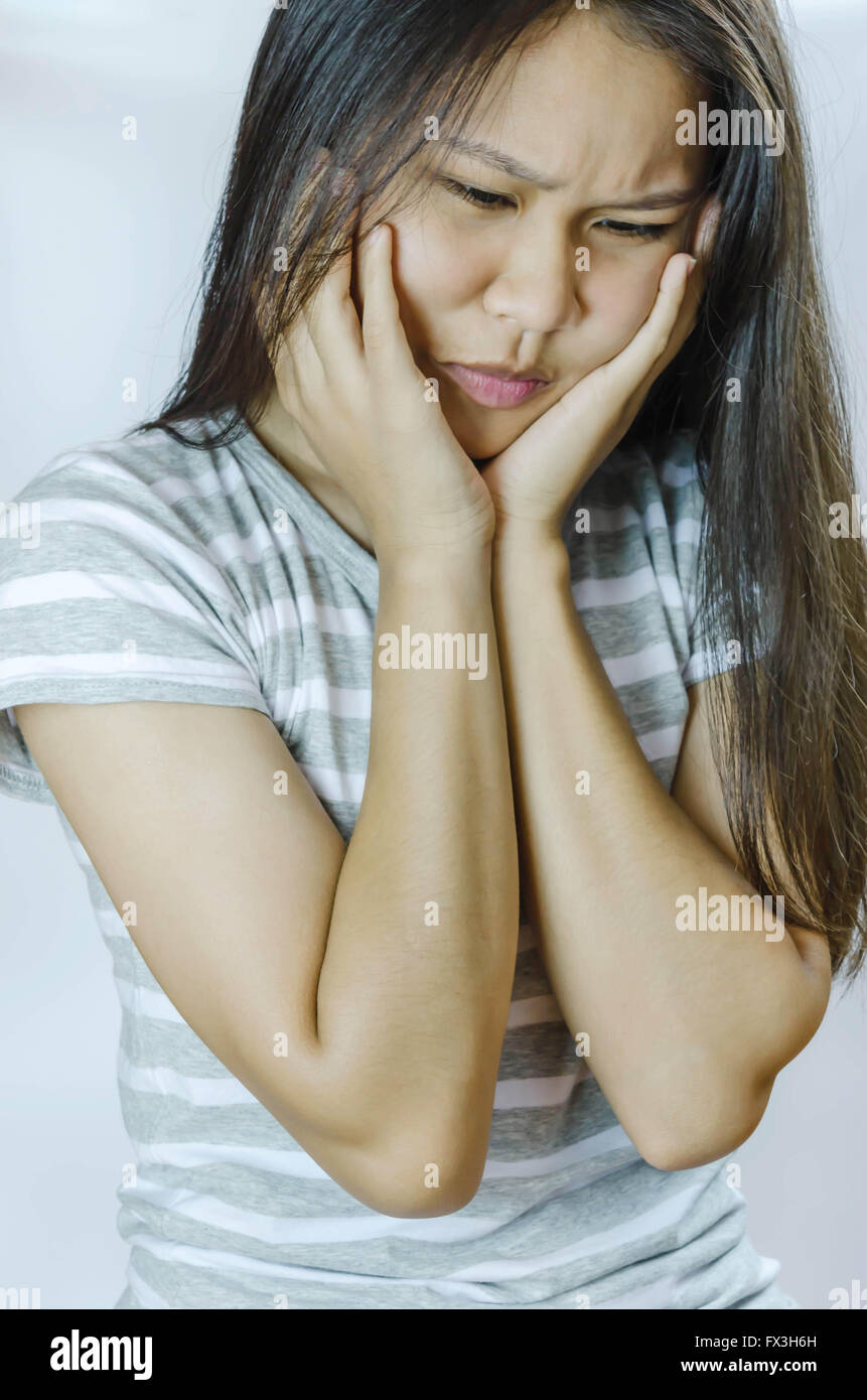 young woman is having strong headache or toothache Stock Photo