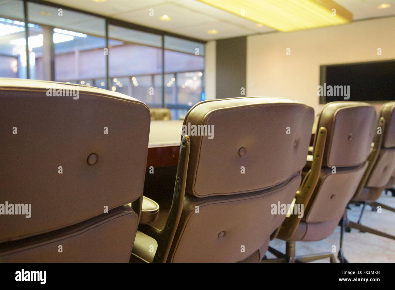 Empty seats at a board room table. Stock Photo