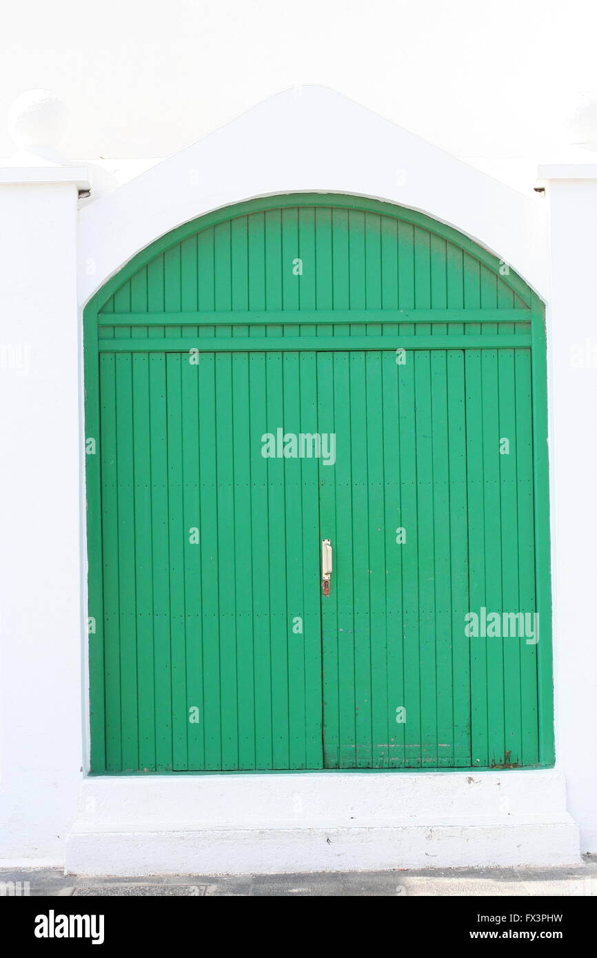 Green wooden double door on a spanish street in Lanzarote, Spain spanish architecture, clean Stock Photo