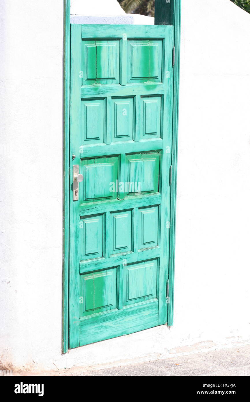 Green door on a spanish street summers day Lanzarote Spanish Island street, Lanzarote Spain spanish living concept, washed out, panels panelled Stock Photo
