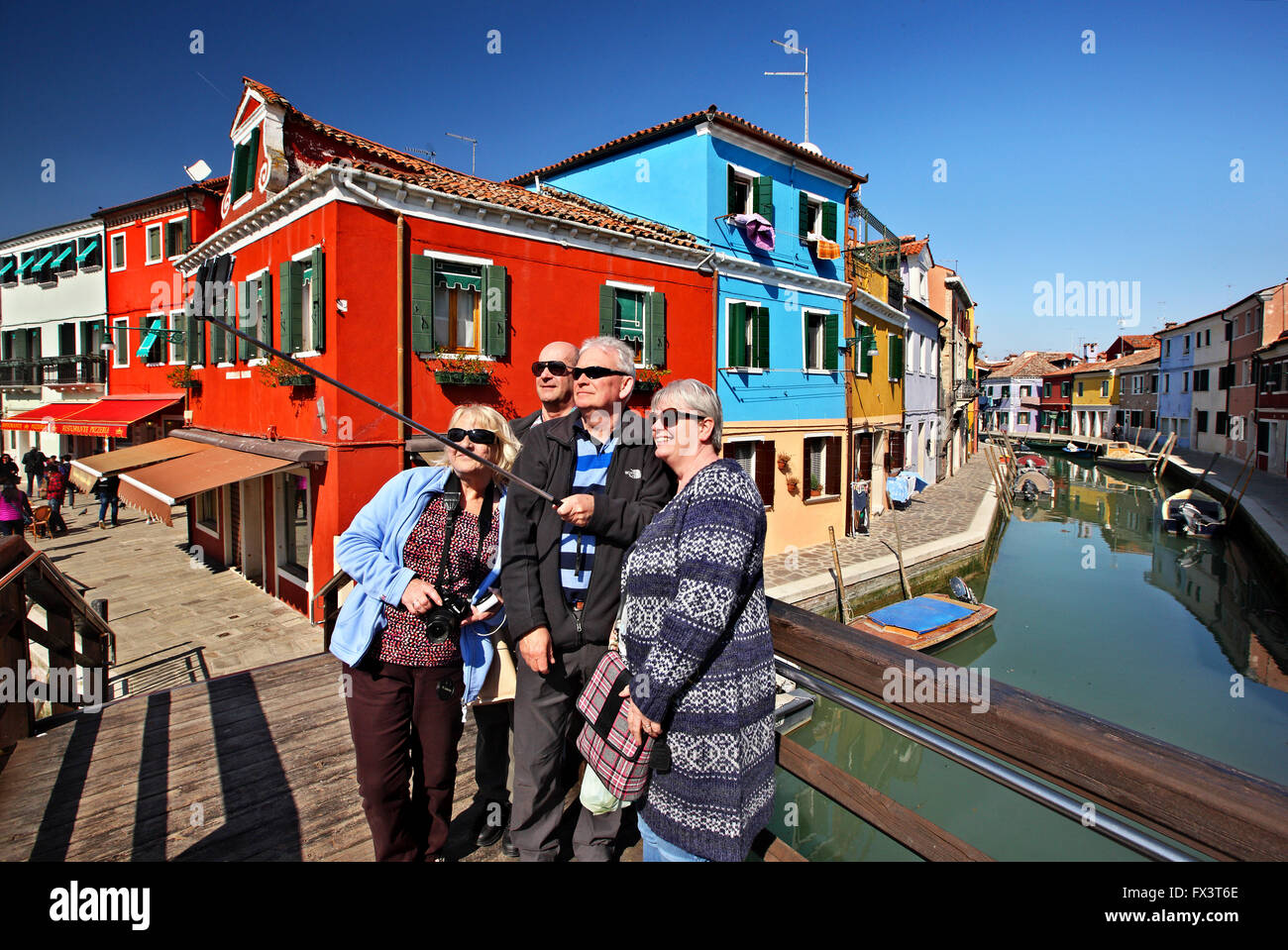 'Selfie' in front of colorful houses of picturesque  Burano island, Venice, Veneto, Italy. Stock Photo