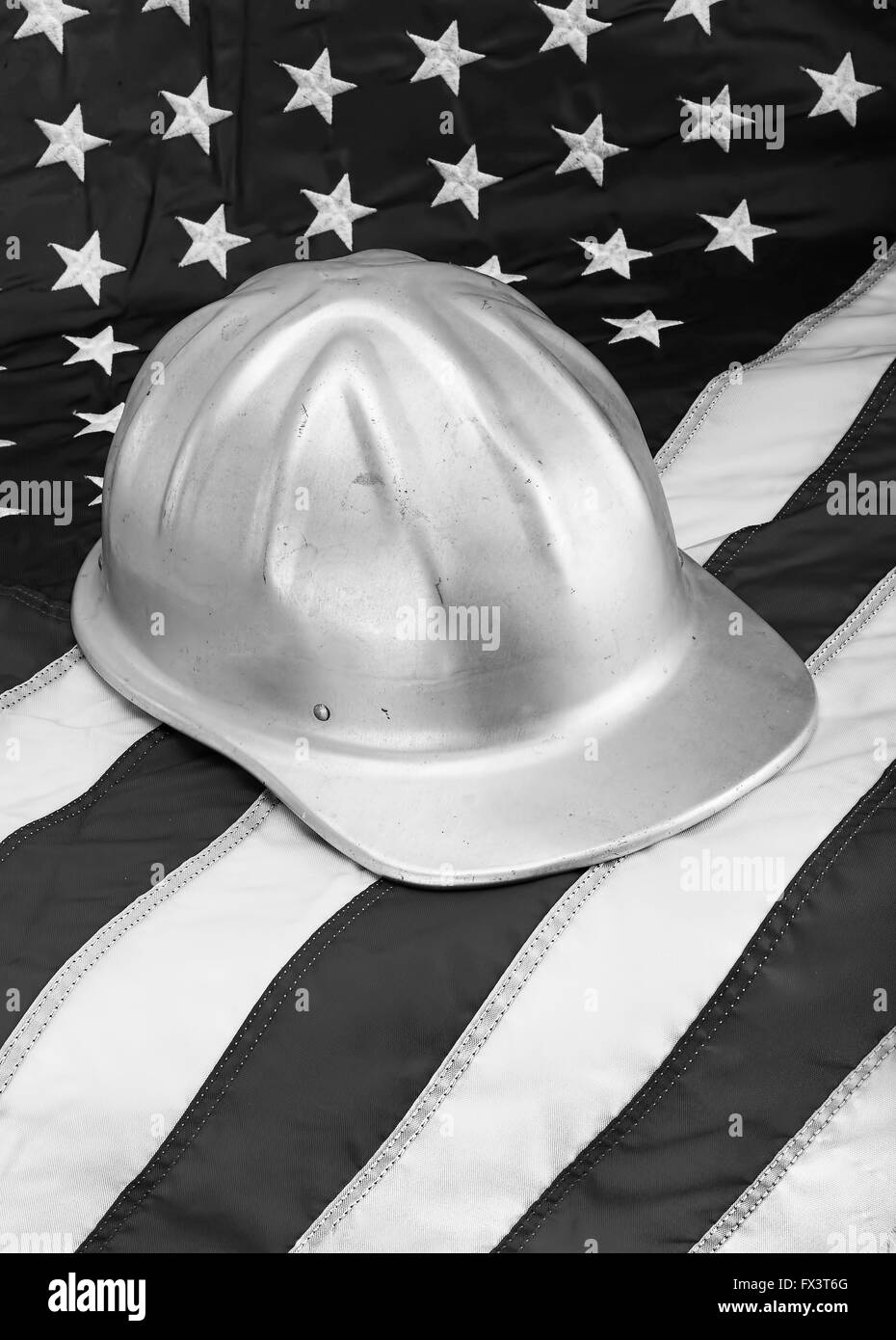 Hard hat on American flag in black and white. Stock Photo