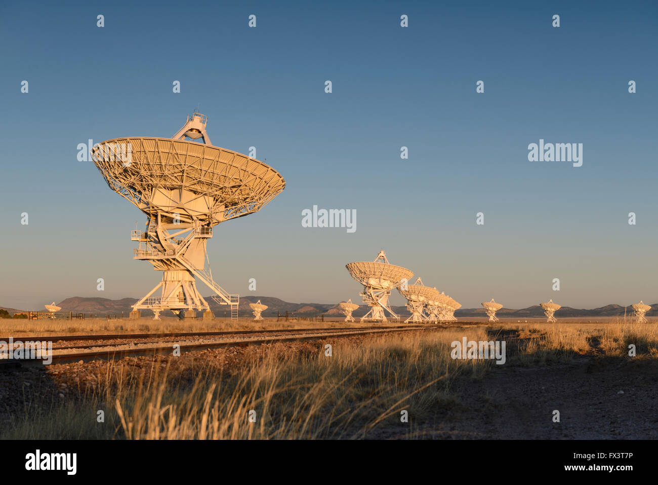 Sunrise Huge antenna dish at Very Large Array, searching for imaging signal in space, silhouette Stock Photo