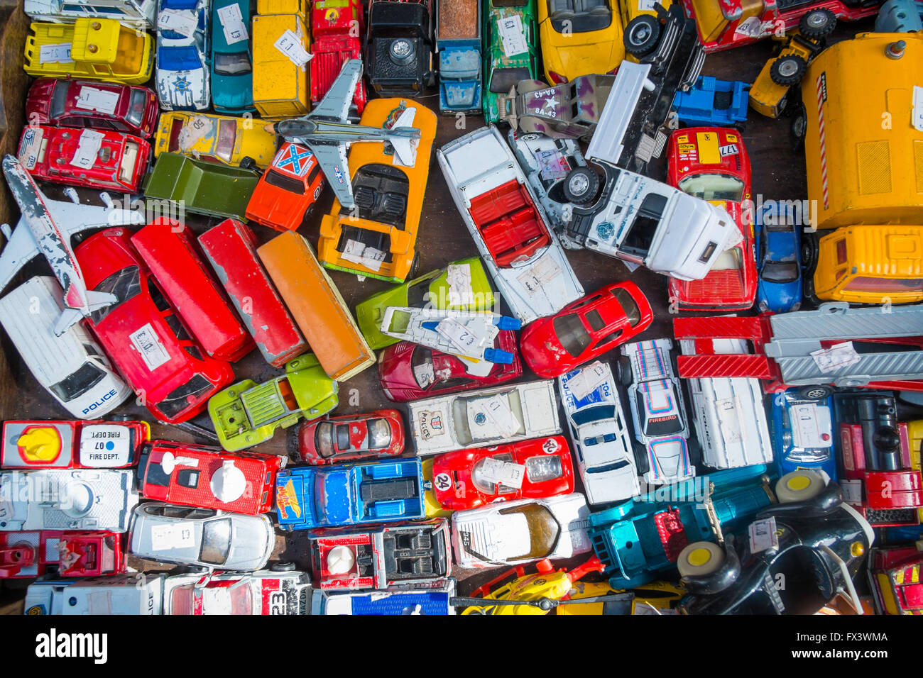 A collection of assorted vintage toy vehicles in a box in an English antique shop Stock Photo
