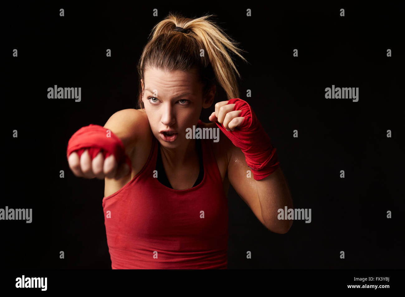 Young blonde woman shadow boxing, throwing a punch Stock Photo Alamy