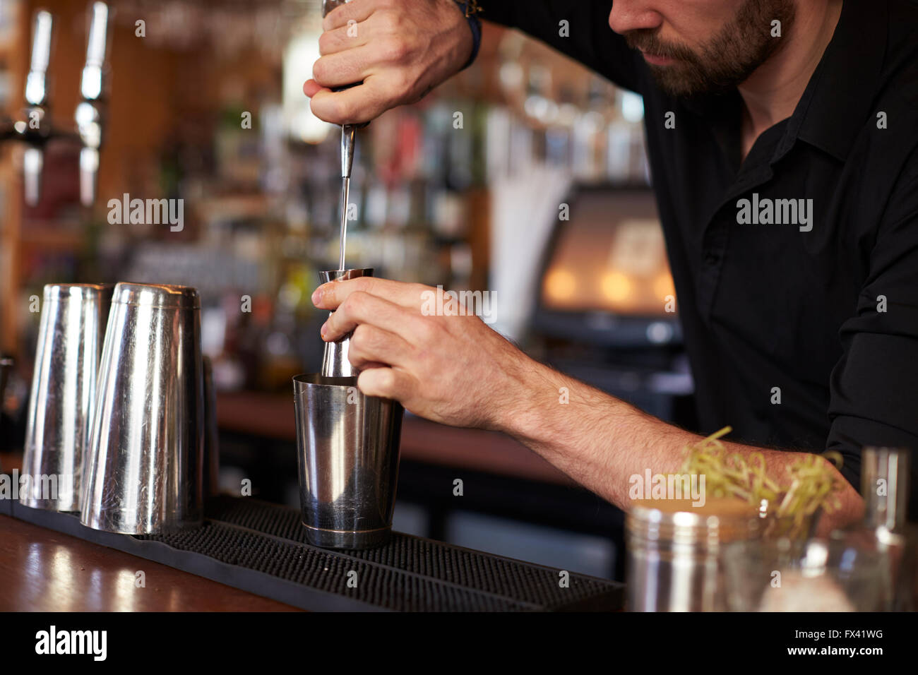 Close Up Of Barman Mixing Cocktail On Counter Stock Photo
