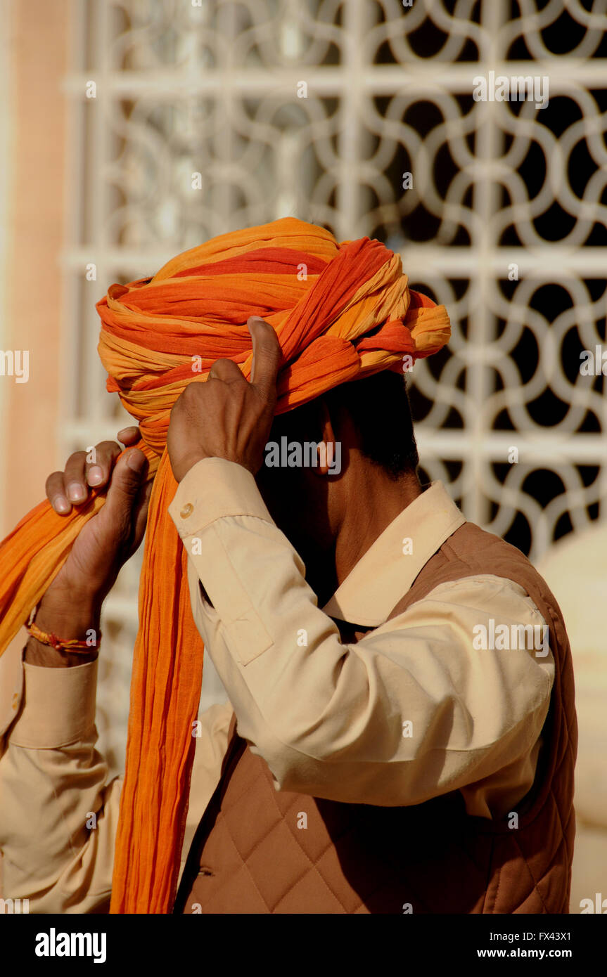 A man demonstrates how to put on a turban. He did this for tourist visitors to Jodhpur's Meherangarth Fort. Stock Photo